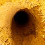 Alzando lo sguardo notiamo invece dei pozzetti circolari. Si tratta di buchi che permettono di arieggiare i locali: furono probabilmente realizzati (o ampliati) durante il periodo bellico